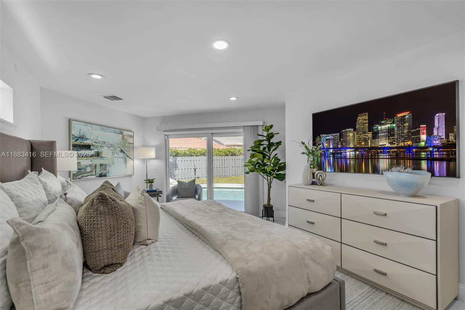 465 Northwest 11th Street Boca Raton, FL 33432 - Photo 21 of 50 a spacious bedroom with a large bed and a flat tv screen on dresser