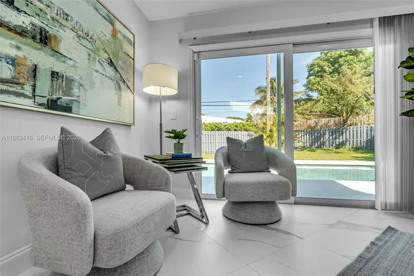 a living room with furniture and a large window