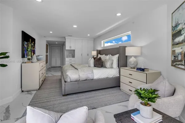 a bedroom with a bed and a couch