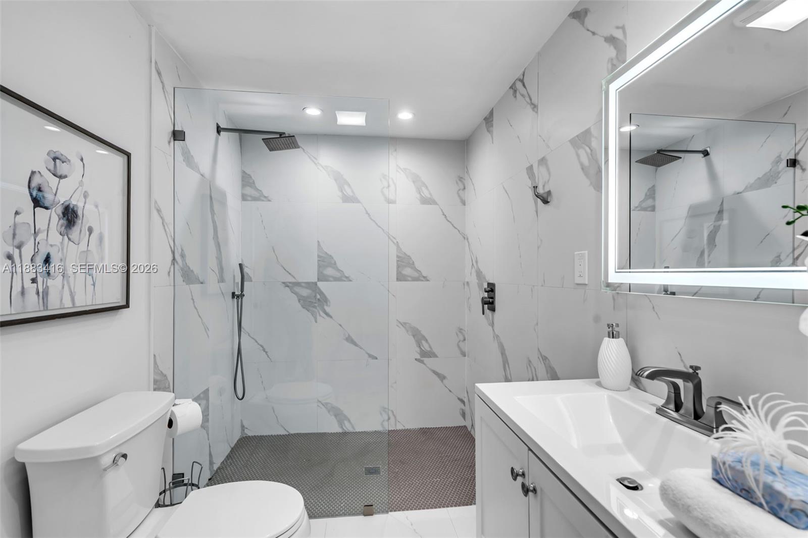 465 Northwest 11th Street Boca Raton, FL 33432 - Photo 26 of 50 a bathroom with a sink toilet vanity and shower