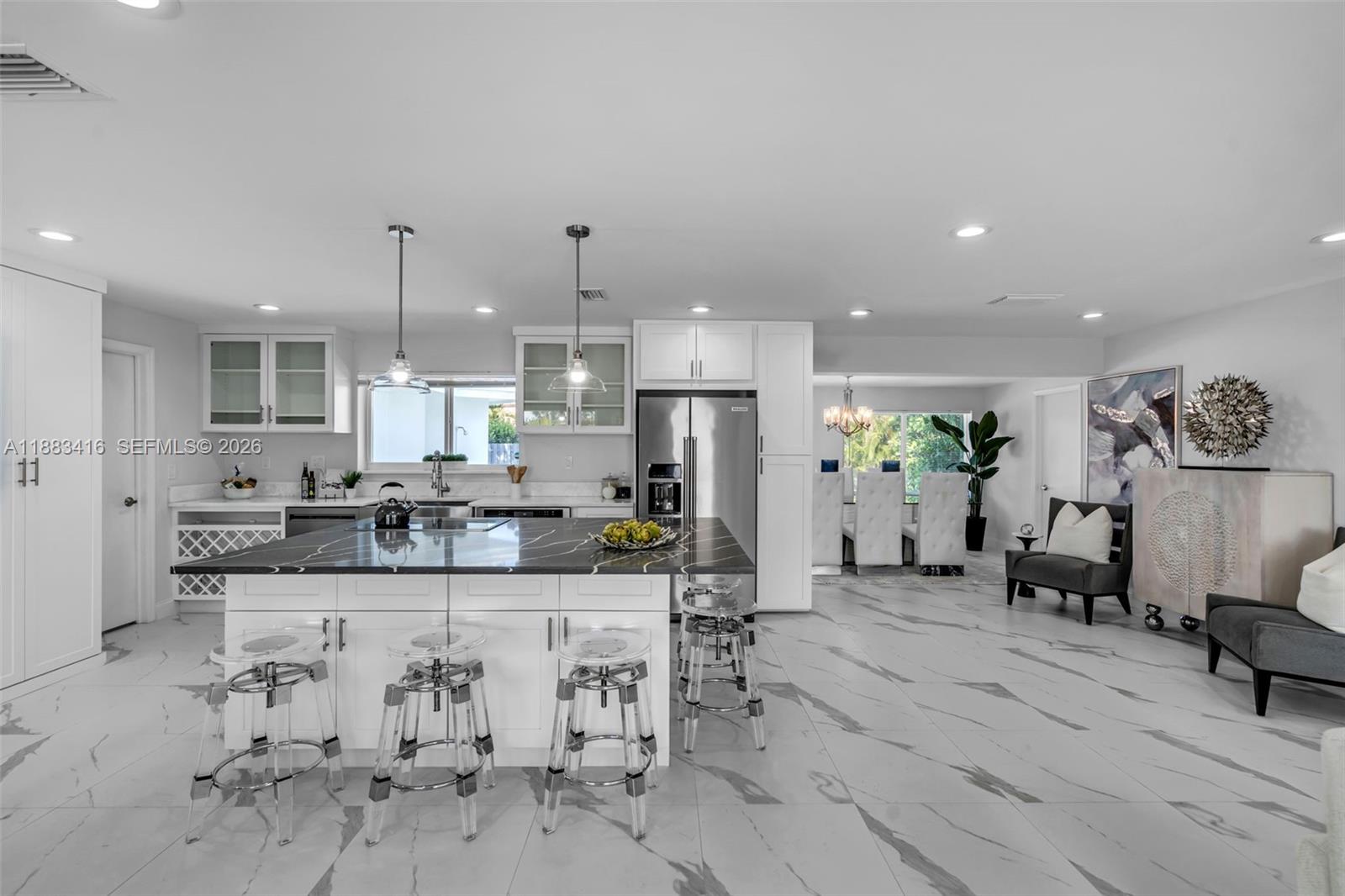 465 Northwest 11th Street Boca Raton, FL 33432 - Photo 3 of 50 a large white kitchen with lots of counter space and living room view