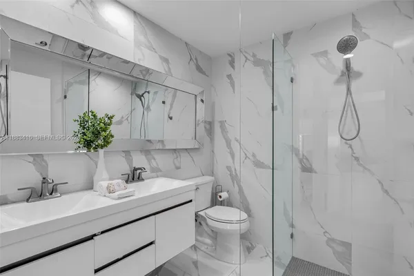 a bathroom with a sink toilet and shower