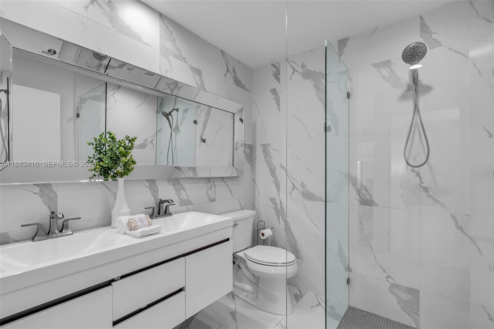 465 Northwest 11th Street Boca Raton, FL 33432 - Photo 32 of 50 a bathroom with a sink toilet and shower