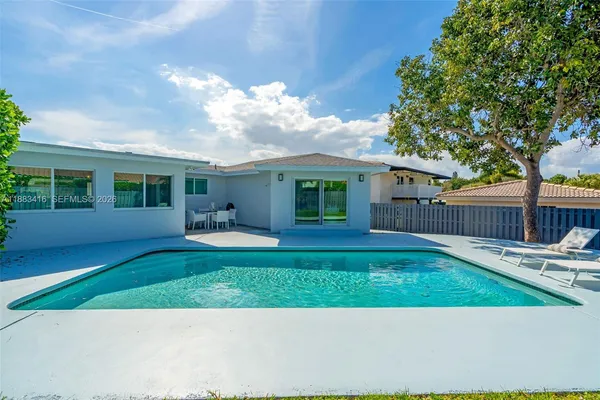 a view of a house with a yard and sitting area