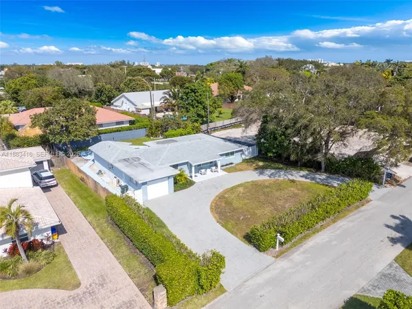 an aerial view of residential houses with outdoor space and swimming pool