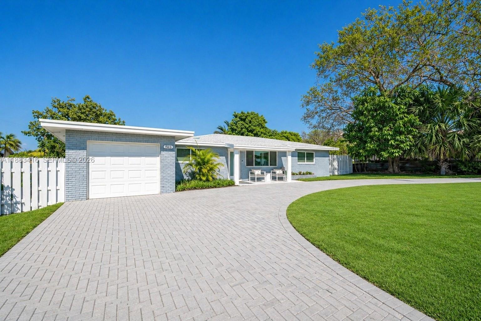 465 Northwest 11th Street Boca Raton, FL 33432 - Photo 9 of 50 a front view of a house with a yard