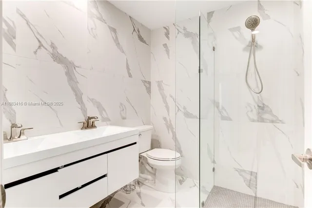 a bathroom with a sink toilet and shower