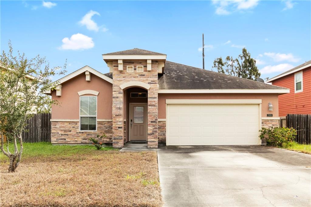 3984 Ridge Trail Brownsville, TX 78520 - Photo 1 of 1 View of front of property with a garage and a front lawn