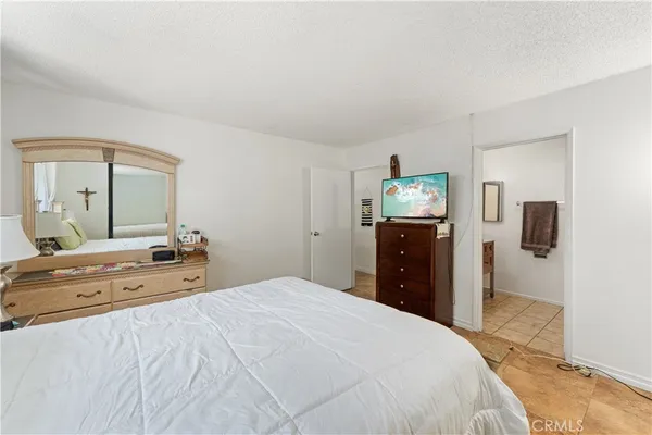 a bathroom with a granite countertop sink toilet a mirror and shower