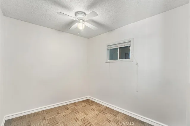 an empty room with a fan