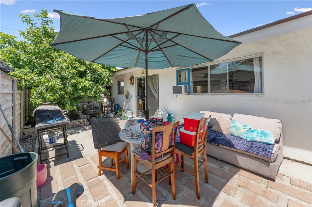 14802 Newport Avenue, Unit 18A Tustin, CA 92780 - Photo 21 of 27 a view of an outdoor sitting area with furniture and umbrella