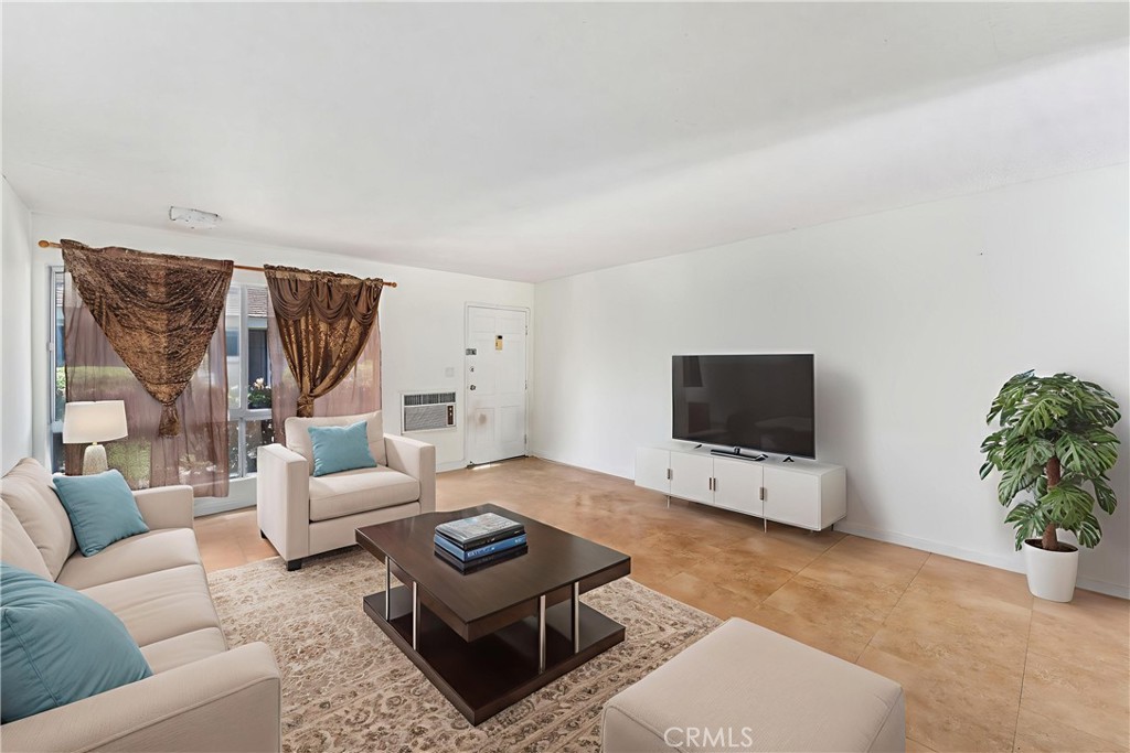 14802 Newport Avenue, Unit 18A Tustin, CA 92780 - Photo 3 of 27 a living room with furniture and a flat screen tv