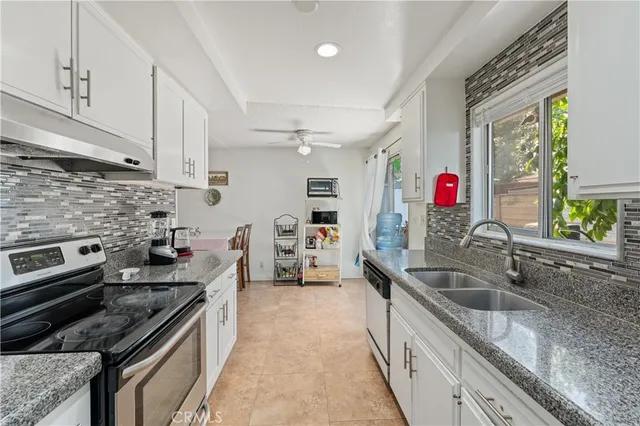 a kitchen with granite countertop a sink and cabinets