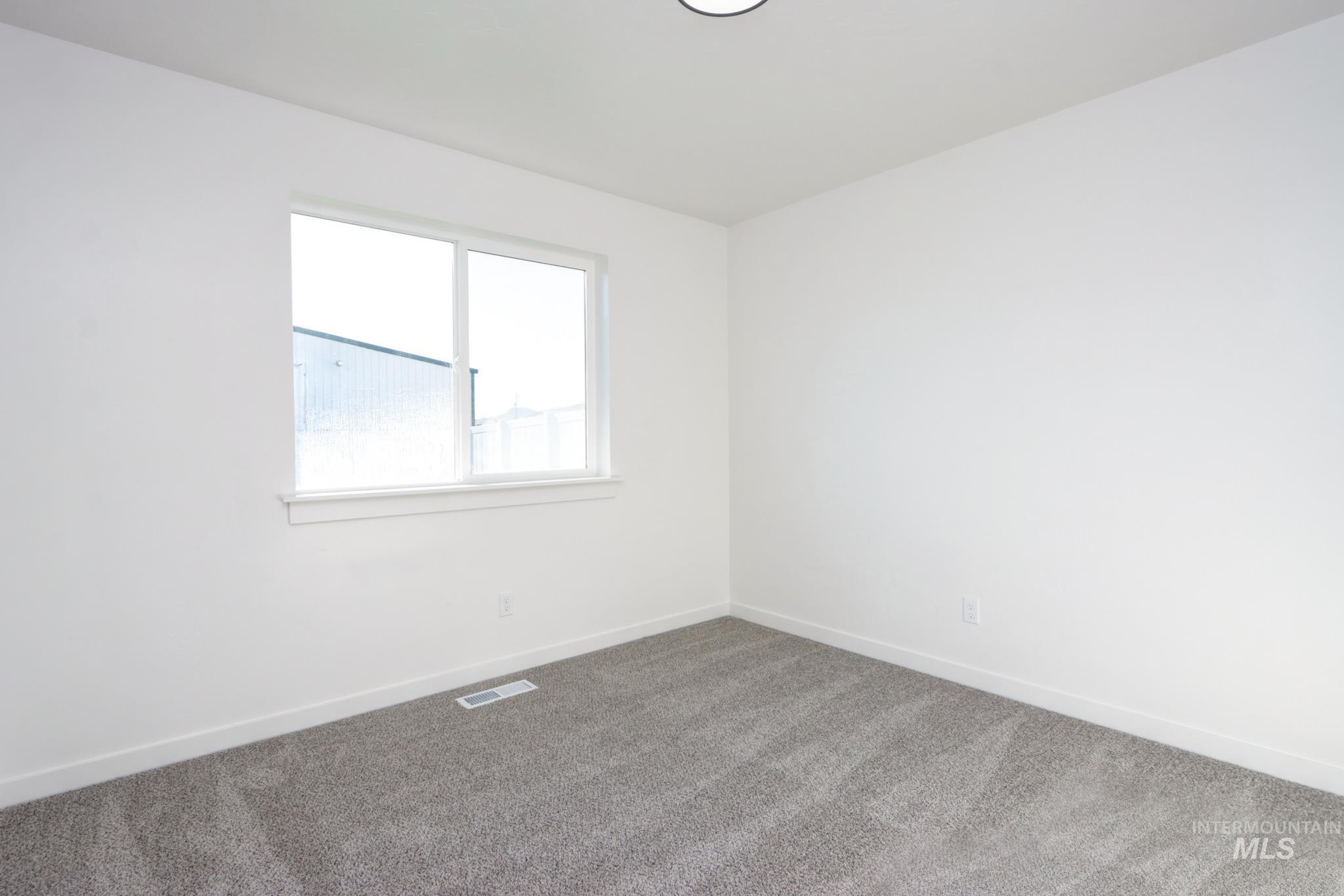 848 North 5th Street Nyssa, OR 97913 - Photo 25 of 49 Neutral painted walls with a single window and light gray carpeting