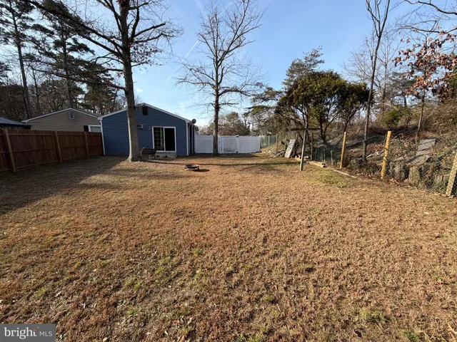 a tall house with trees in front of it