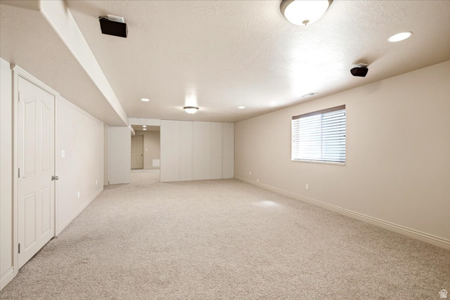 1089 West 2325th Street North Layton, UT 84041 - Photo 26 of 40 Spacious carpeted room featuring recessed lighting, a built-in speaker system, and a window with horizontal blinds