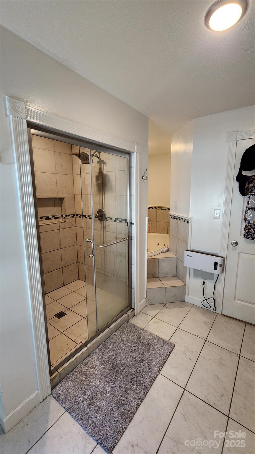 1235 Sulphur Springs Road Waynesville, NC 28786 - Photo 11 of 40 a bathroom with a shower and mirror