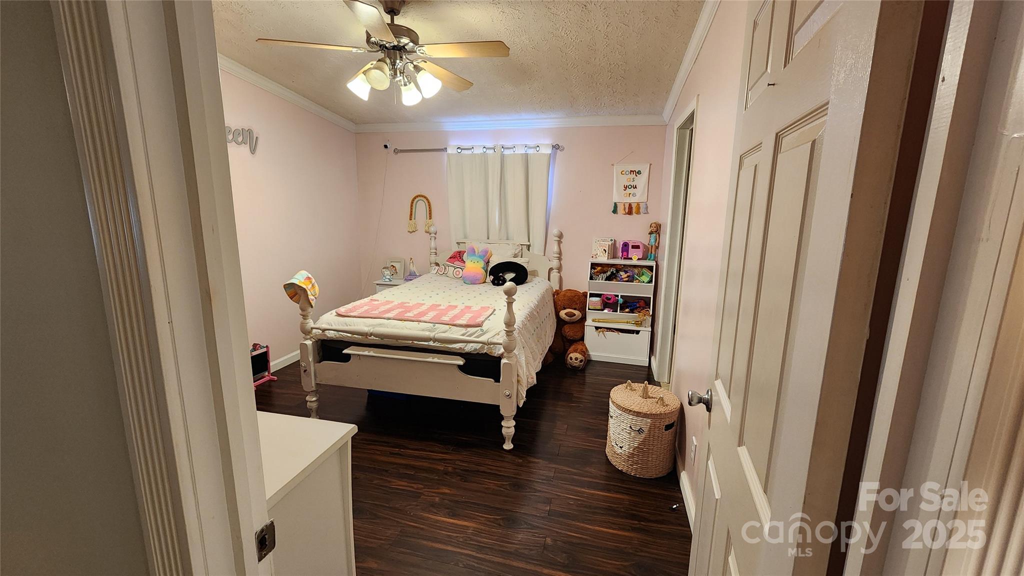 1235 Sulphur Springs Road Waynesville, NC 28786 - Photo 15 of 40 a bedroom with a bed and a chandelier