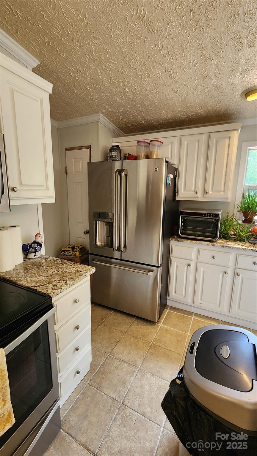 1235 Sulphur Springs Road Waynesville, NC 28786 - Photo 20 of 40 a kitchen with granite countertop a stove and a refrigerator