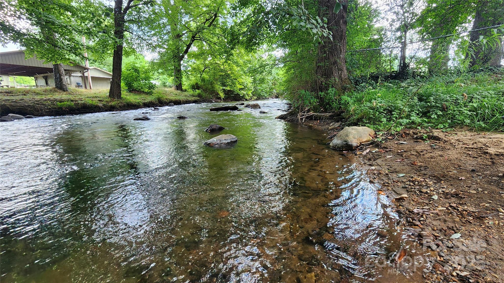 1235 Sulphur Springs Road Waynesville, NC 28786 - Photo 35 of 40 a view of a lake with a yard