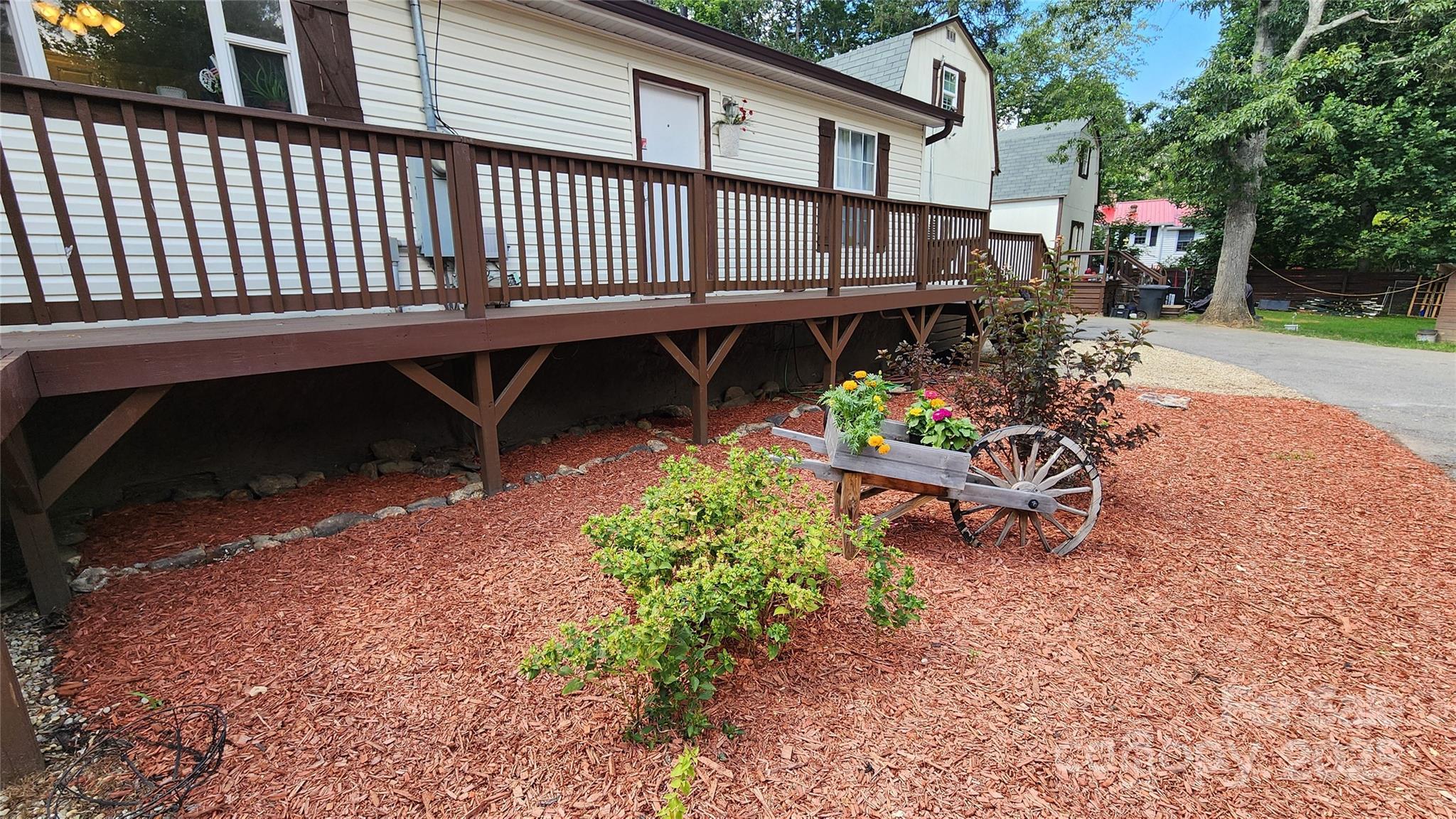1235 Sulphur Springs Road Waynesville, NC 28786 - Photo 5 of 40 a view of a chair and table in the backyard