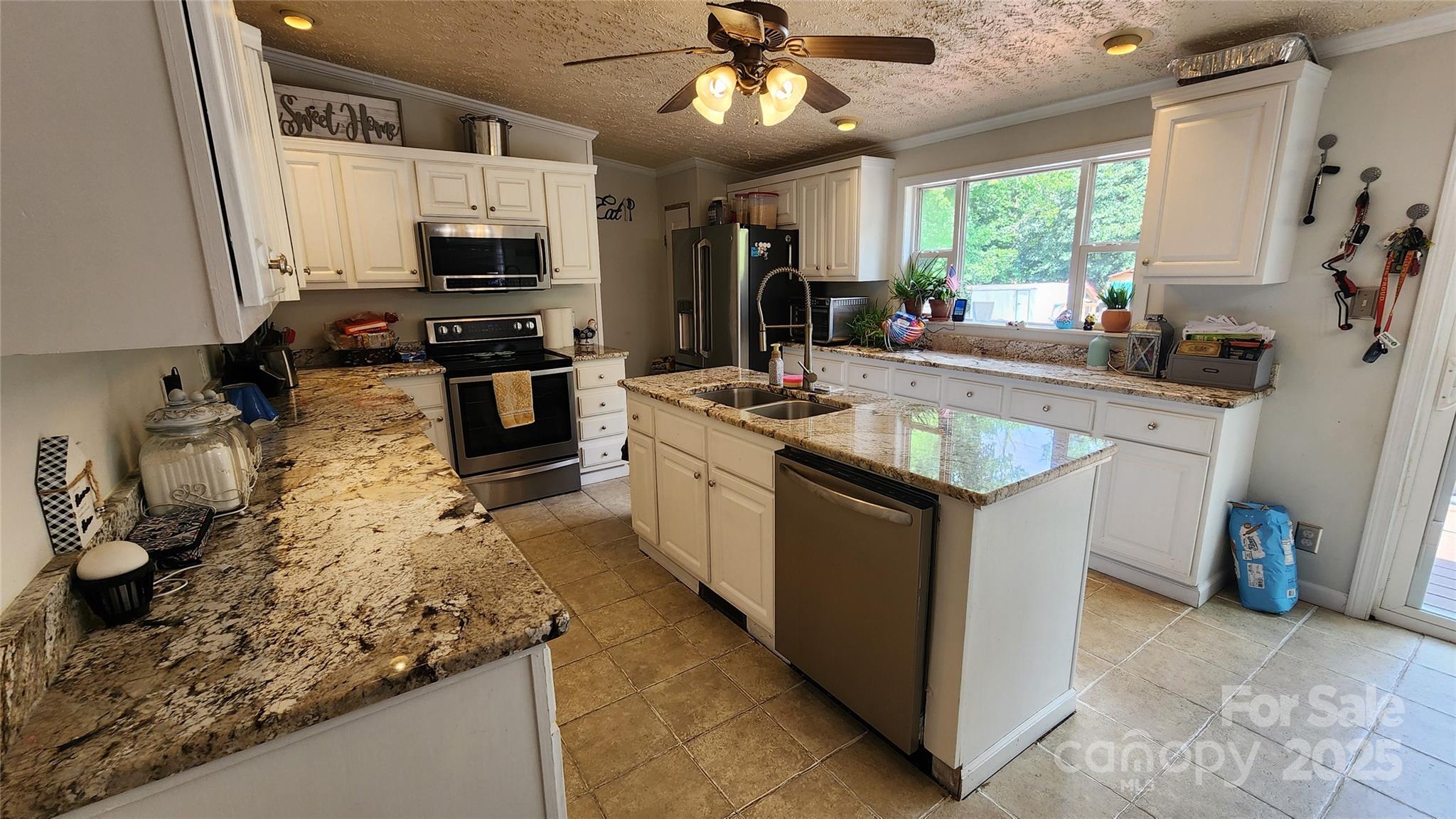 1235 Sulphur Springs Road Waynesville, NC 28786 - Photo 7 of 40 a kitchen with stainless steel appliances granite countertop a stove refrigerator sink and microwave