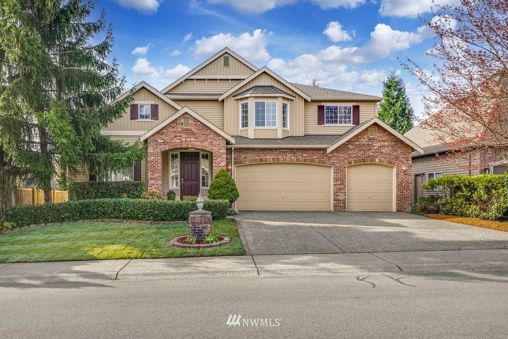 3620 209th Place Southeast Bothell, WA 98021 - Photo 1 of 31 a front view of a house with a yard and garage
