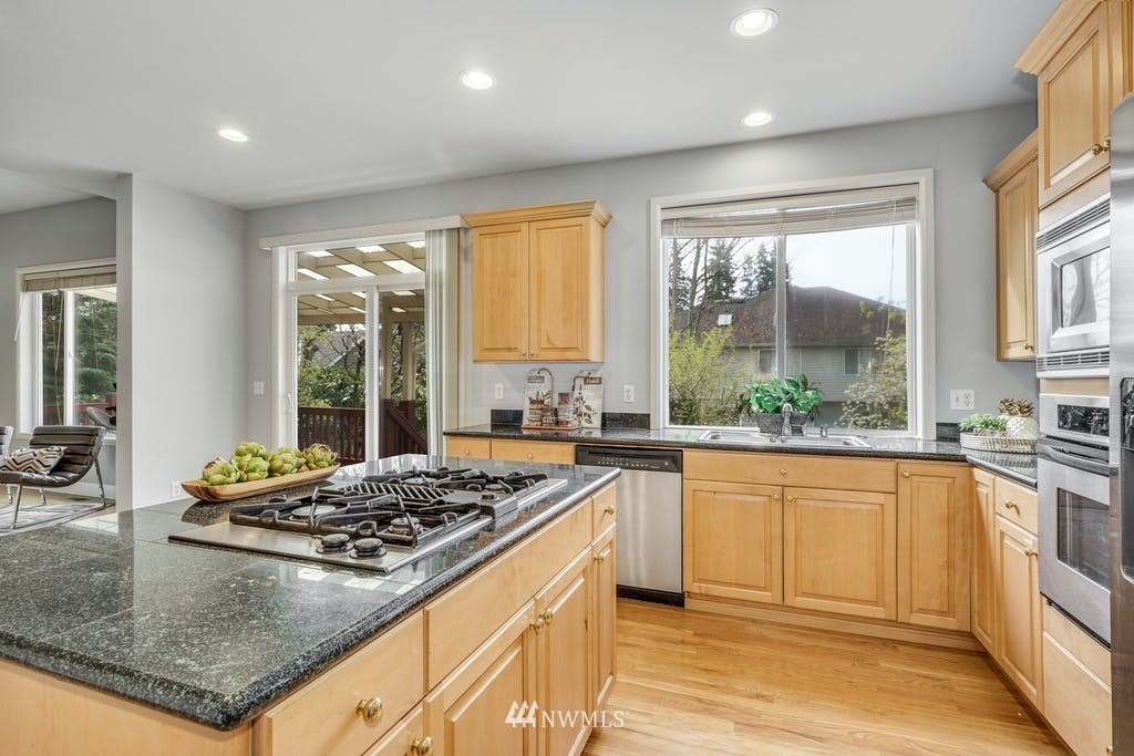 3620 209th Place Southeast Bothell, WA 98021 - Photo 12 of 31 a kitchen with kitchen island a stove a sink and a granite counter top