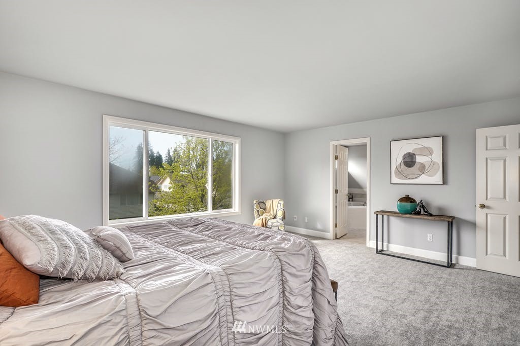 3620 209th Place Southeast Bothell, WA 98021 - Photo 15 of 31 a bedroom with a bed and a chandelier