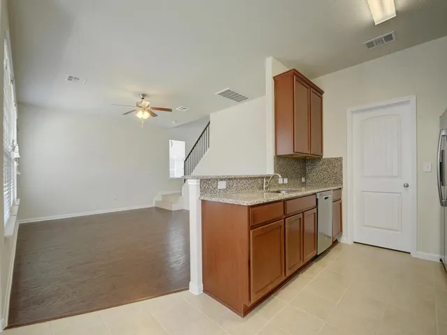 a kitchen with stainless steel appliances granite countertop a stove and a sink