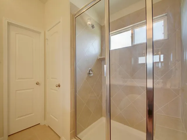 a bathroom with a glass shower door
