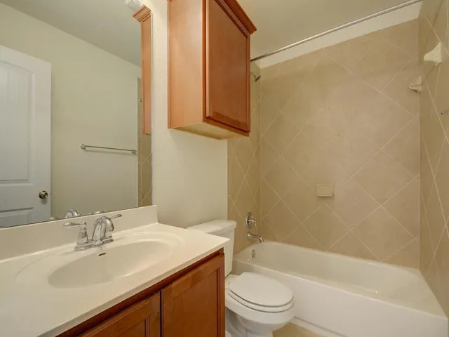 a bathroom with a sink a toilet and bathtub