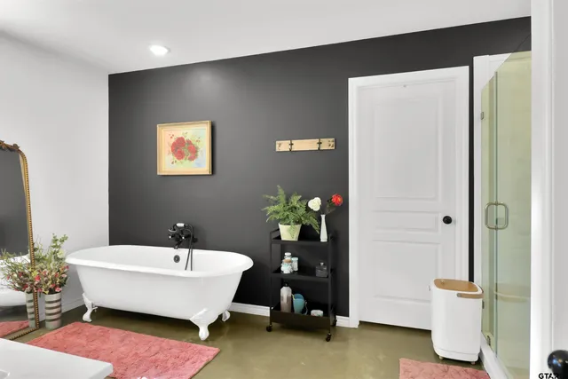 a spacious bathroom with a bathtub and a shower