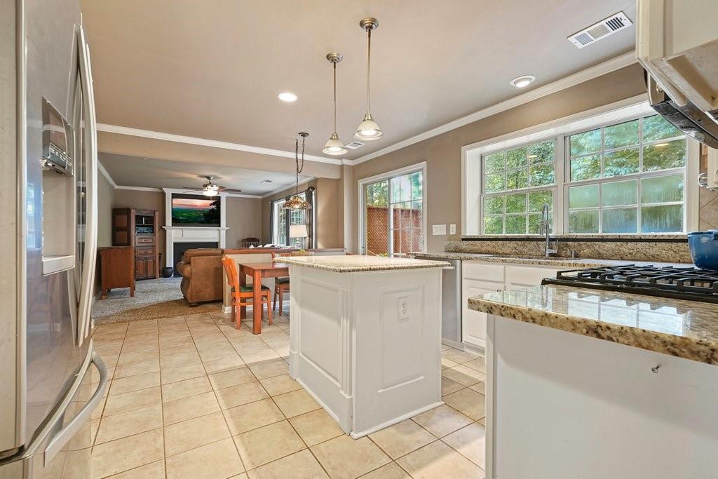 7335 Lytham Trace Cumming, GA 30041 - Photo 11 of 45 a kitchen with stainless steel appliances granite countertop a stove and a sink