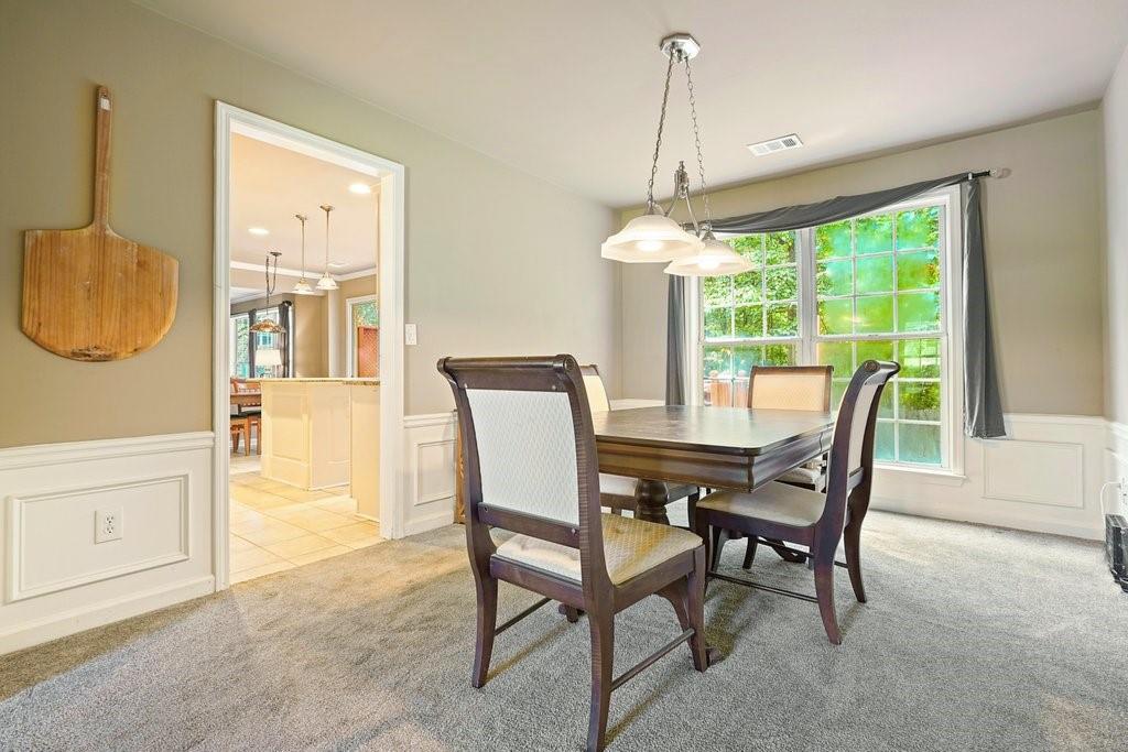 7335 Lytham Trace Cumming, GA 30041 - Photo 16 of 45 a dining room with furniture and window