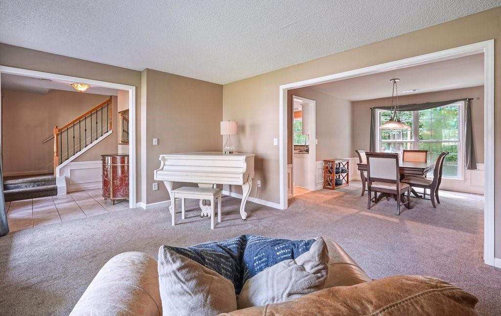 7335 Lytham Trace Cumming, GA 30041 - Photo 17 of 45 a living room with furniture and a large window