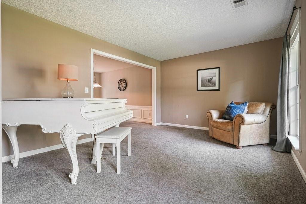 7335 Lytham Trace Cumming, GA 30041 - Photo 18 of 45 a dining room with furniture and a window