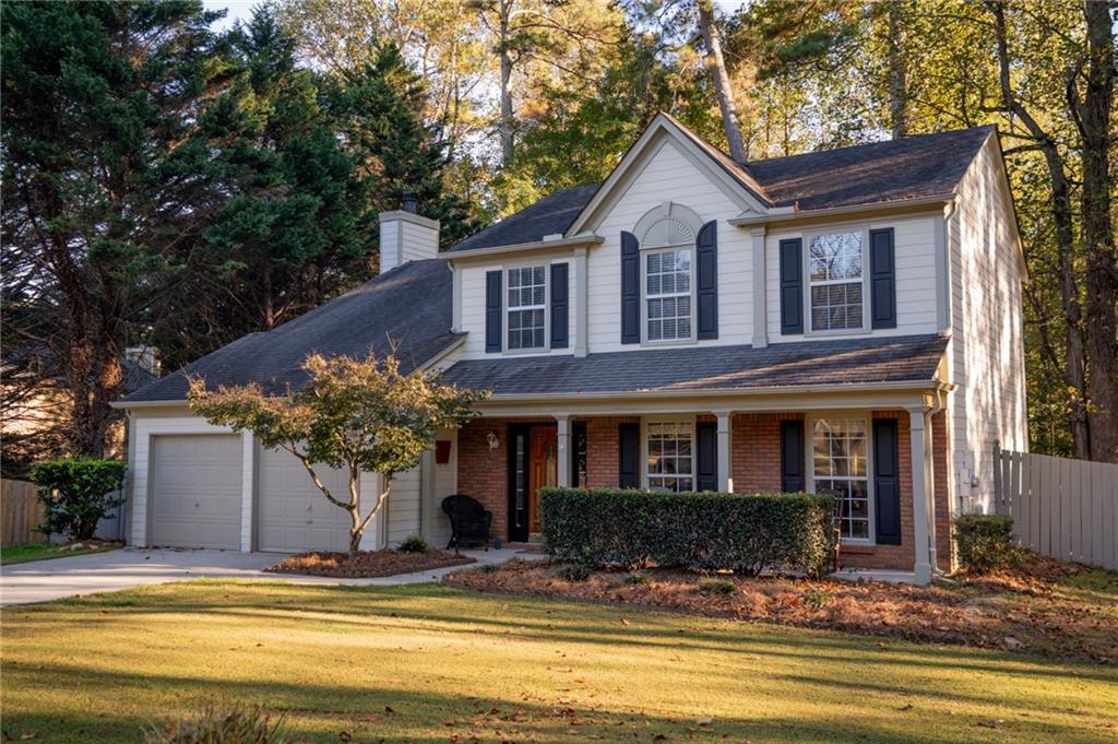 7335 Lytham Trace Cumming, GA 30041 - Photo 2 of 45 a front view of a house with a porch and a yard