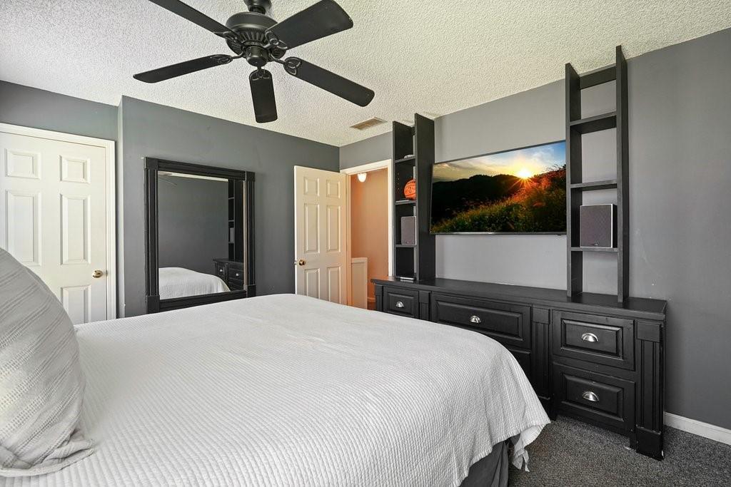 7335 Lytham Trace Cumming, GA 30041 - Photo 26 of 45 a bedroom with a bed and a flat screen tv