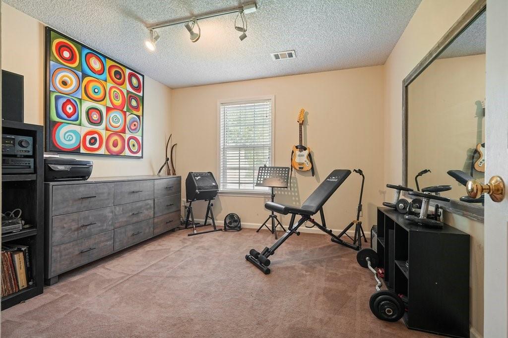 7335 Lytham Trace Cumming, GA 30041 - Photo 30 of 45 a view of a room with gym equipment
