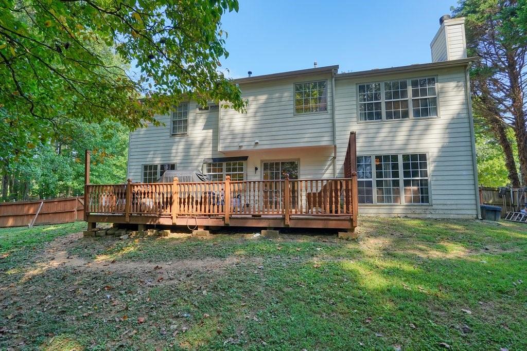 7335 Lytham Trace Cumming, GA 30041 - Photo 33 of 45 a view of a house with a yard and deck