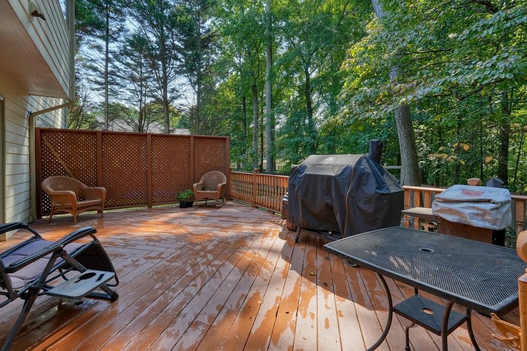 7335 Lytham Trace Cumming, GA 30041 - Photo 35 of 45 a backyard of a house with barbeque oven and outdoor seating