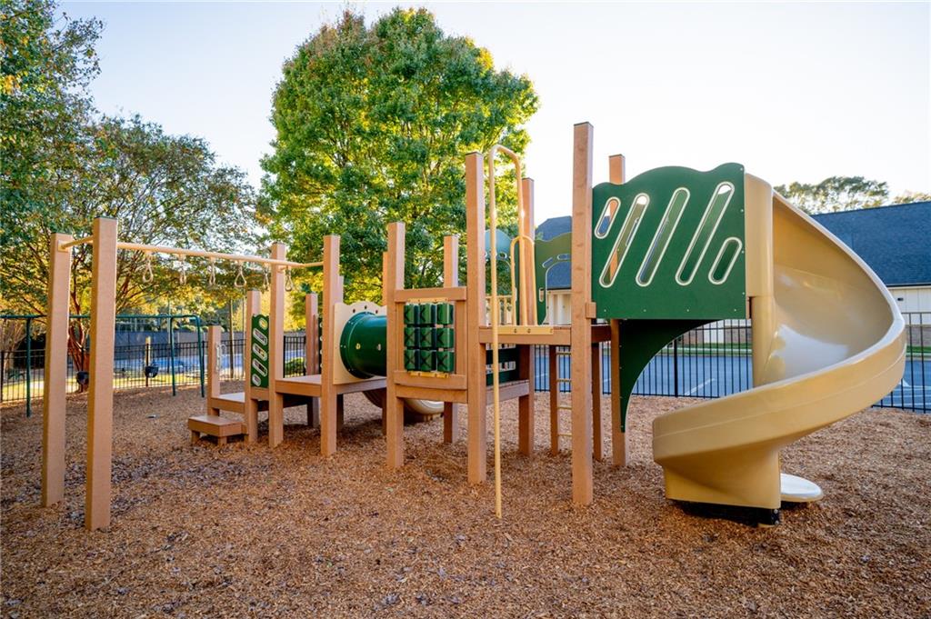 7335 Lytham Trace Cumming, GA 30041 - Photo 41 of 45 a blue bench sitting in front of a house