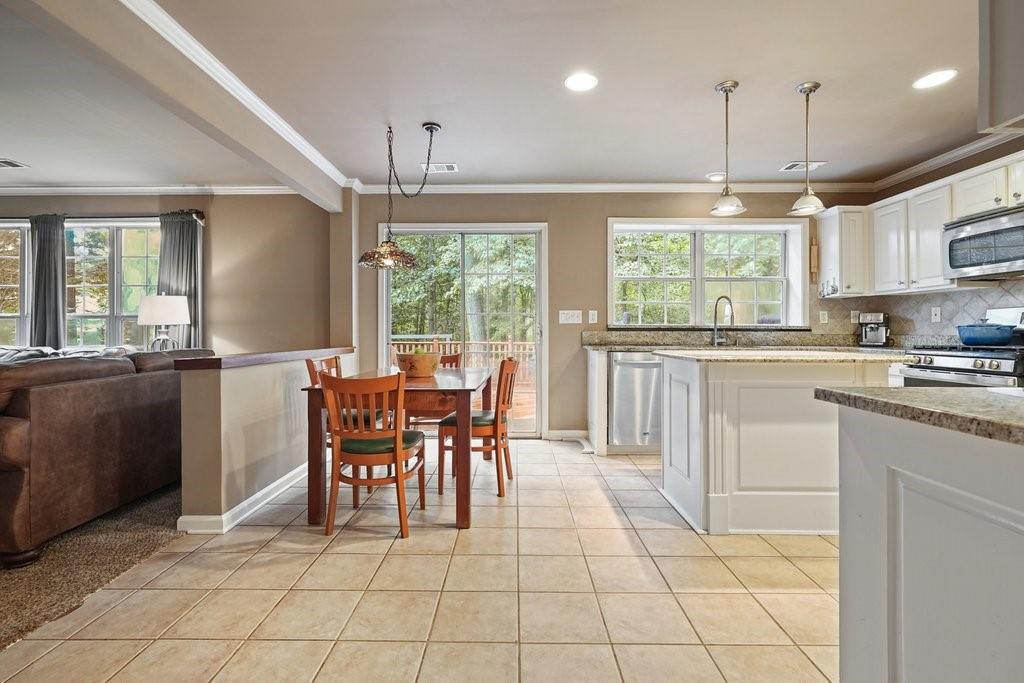 7335 Lytham Trace Cumming, GA 30041 - Photo 10 of 45 a kitchen with kitchen island granite countertop a counter top space appliances and a cabinets