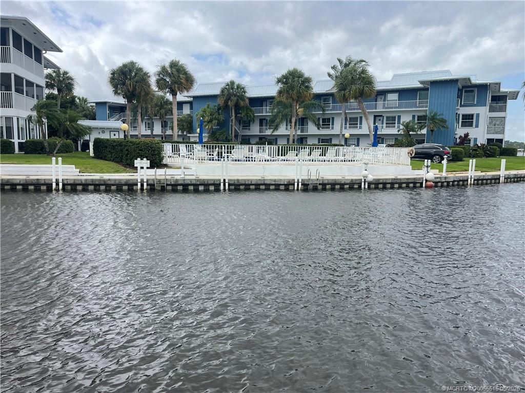 a view of a lake with a house and swimming pool