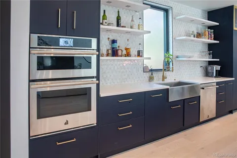 a kitchen with a sink and a refrigerator