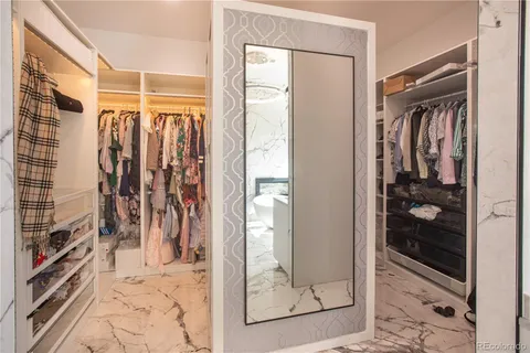 a room with lots of chairs and mirrors