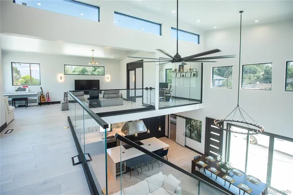 a living room with furniture and floor to ceiling windows