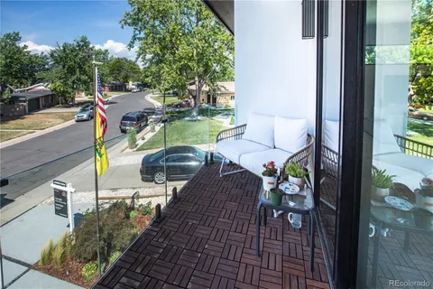a view of a livingroom with furniture and a dining table with wooden floor