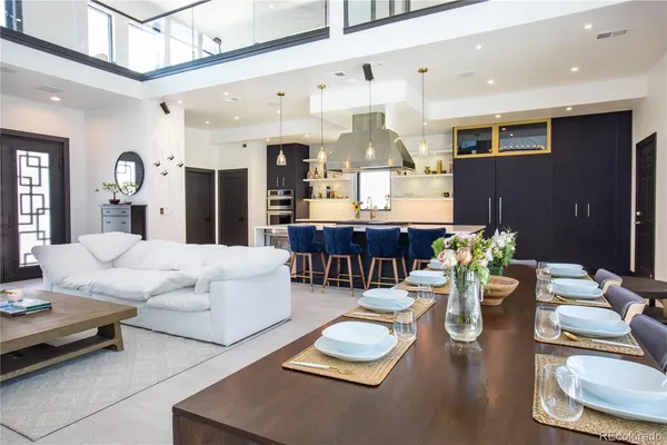 a kitchen with kitchen island a stove a table and chairs in it